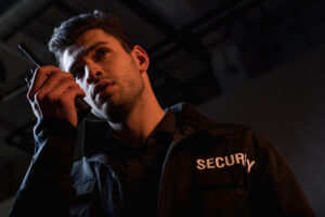 guard in uniform using walkie-talkie