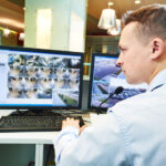 security guard officer watching video monitoring surveillance security system