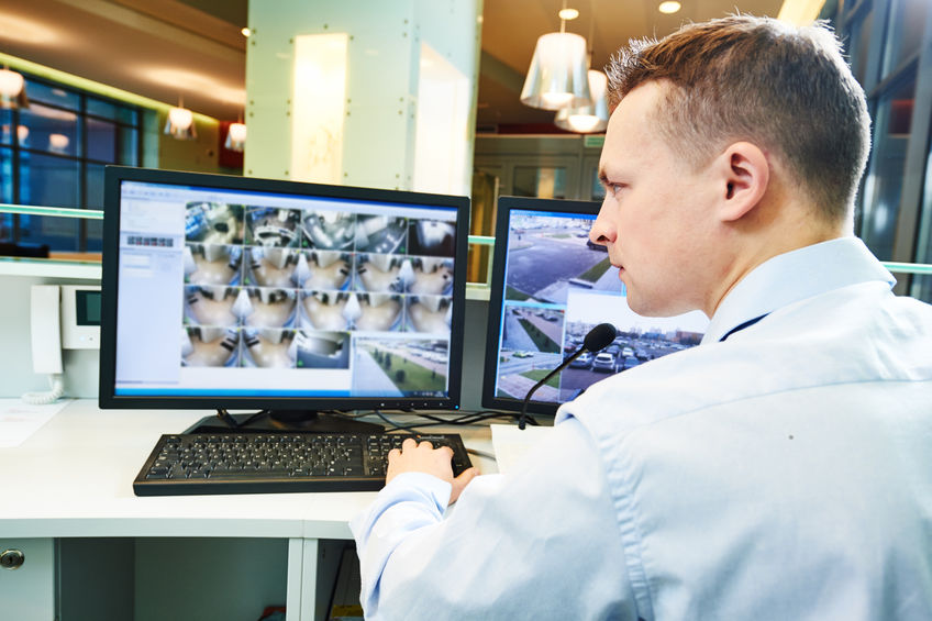 security guard officer watching video monitoring surveillance security system