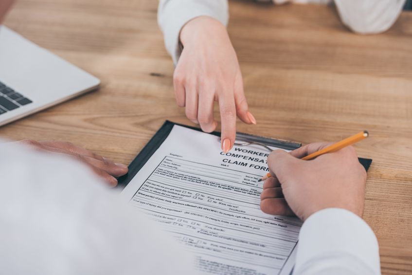 View of a worker filling out a Workers' Compensation claim
